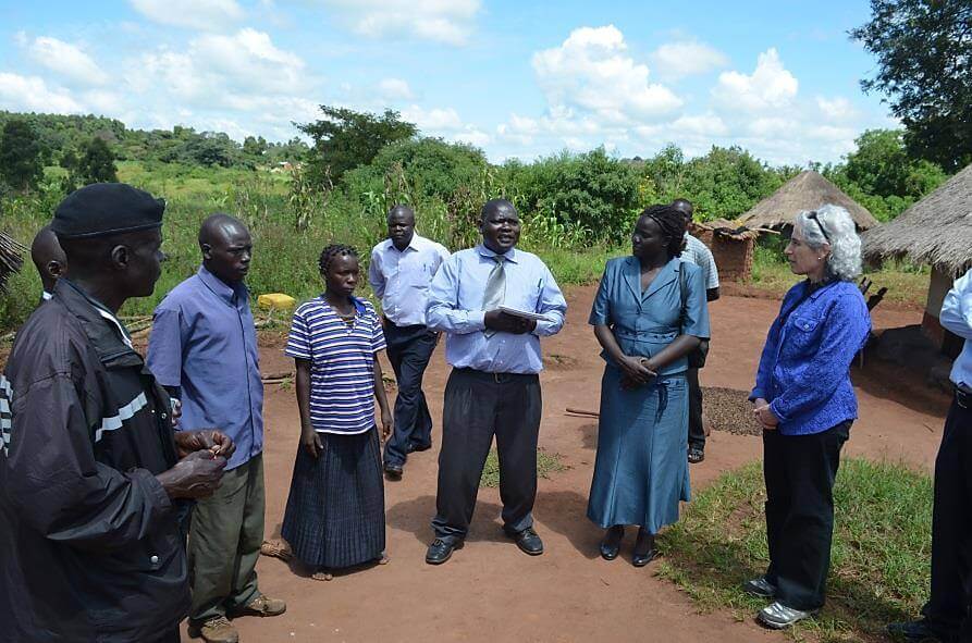 In October 2012, Dr. Bell (far right) visited Uganda and met a farmer (third from left) who had developed symptoms of plague. He was promptly                 tested with the plague dipstick test and learned within 15 minutes that he had tested positive for plague. He was treated with antibiotics,                 fully recovered, and was back working in 3 days. Also pictured is Ugandan clinical coordinator Dr. Titus Apangu (center, wearing a tie).  Photo credit: NCEZID